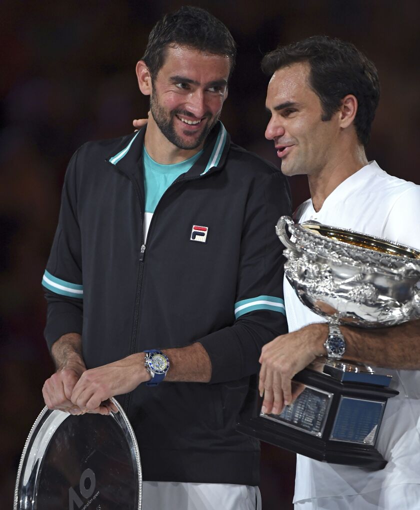 Switzerland’s Roger Federer, right, talks with Croatia’s Marin Cilic during awarding ceremony after he won their men’s singles final at the Australian Open tennis championships in Melbourne, Australia, on Sunday. | AP photo